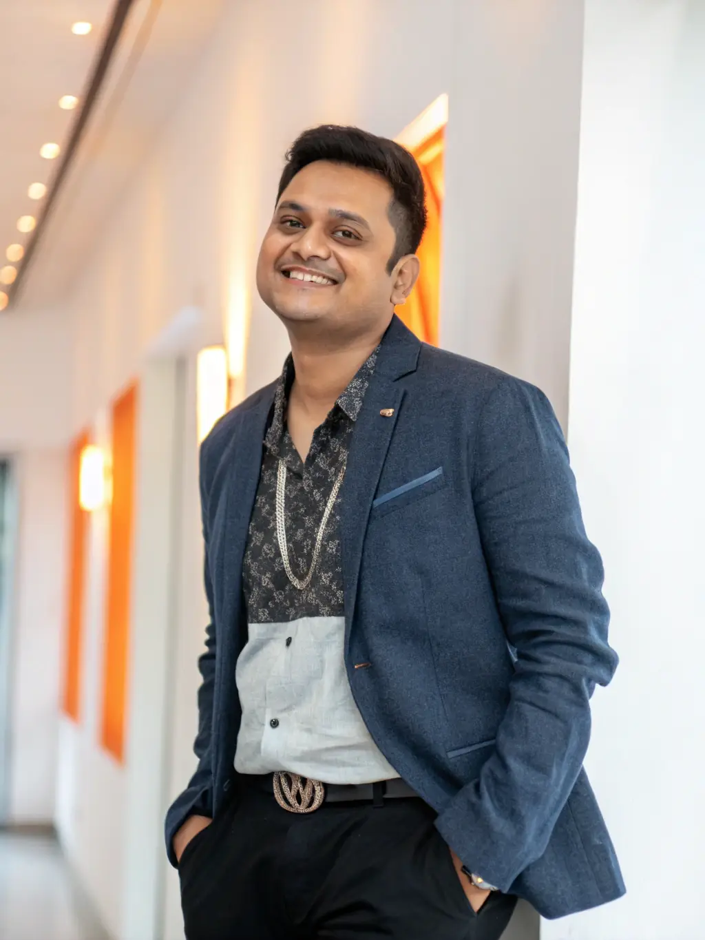 A professional headshot of an artist who has been supported by PULSAR FACTORY, accompanied by a brief testimonial about the organization's impact on their career.